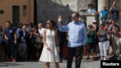 Spain's King Felipe and Queen Letizia greet people as they walk in Old Havana, Cuba, Nov. 12, 2019. 
