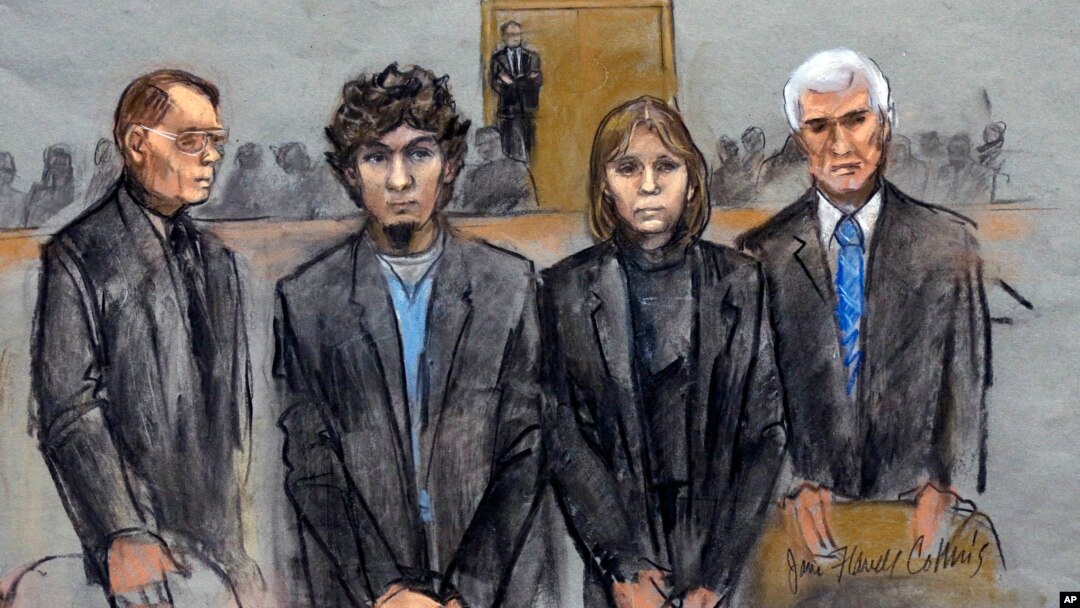 In this courtroom sketch, Dzhokhar Tsarnaev, second from left, is depicted standing with his defense attorneys William Fick, left, Judy Clarke, second from right, and David Bruck, right, as the jury presents its verdict, April 8, 2015.