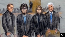 In this courtroom sketch, Dzhokhar Tsarnaev, second from left, is depicted standing with his defense attorneys William Fick, left, Judy Clarke, second from right, and David Bruck, right, as the jury presents its verdict, April 8, 2015.