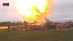 A still image from a video released by the Azerbaijan's Defense Ministry, Sept. 28, shows members of Azeri armed forces firing artillery during clashes between Armenia and Azerbaijan over the territory of Nagorno-Karabakh.
