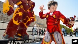 Alfie Ward dressed as Little Iron Man poses in front of the UK’s largest LEGO statue as it is unveiled at the London premiere of LEGO Super Heroes: Marvel’s Avengers Age of Ultron at Westfield Shopping Centre, London.