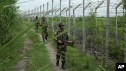 India’s Border Security Force soldiers patrol near the India-Pakistan international border fencing at Garkhal in Akhnoor, west of Jammu, India, Aug. 13, 2019. 