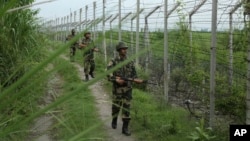 India’s Border Security Force soldiers patrol near the India-Pakistan international border fencing at Garkhal in Akhnoor, west of Jammu, India, Aug. 13, 2019. 