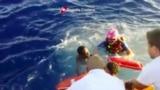 This image made from video provided by the Italian Coast Guard shows the rescue of a survivor from the ship that caught fire and sank off the island of Lampedusa, Italy, Oct. 3, 2013.