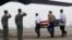 FILE - Pilots salute as U.S. soldiers carry a casket containing human remains, believed to belong to a U.S. servicemen missing in action during the Vietnam War, during a repatriation ceremony at Noi Bai airport in Hanoi, November 2012.