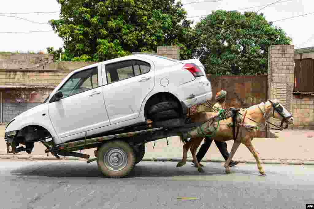 A man transports a car on a horse cart to a repair shop in Amritsar, India.