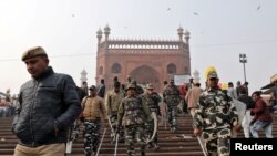 Police patrol the steps of Jama Masjid before Friday prayers in the old quarters of Delhi, India, Dec. 27, 2019. 