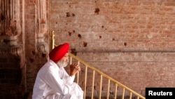 A Sikh man sits beside the wall of one of the complex of Golden Temple hit by the bullet shots during the operation Blue Star in the northern Indian city of Amritsar on June 6, 2010. Indian troops stormed the Golden Temple, the Sikhs' holiest shrine, on June 6, 1984.