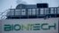 FILE: The logo on the BioNTech biotechnology company displayed at the building where production of the COVID-19 vaccine started, in Marburg, Germany. Taken Feb. 13, 2021.