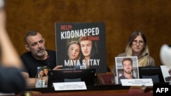 FILE —Ilan Regev Gerby(L) shows a picture of his two kids Maya and Itay, held hostage in Gaza, while sitting next to Idit Ohel (R), mother of Alon Ohel held hostage in Gaza, during a press conference at the European Office of the United Nations in Geneva, on November 14, 2023.