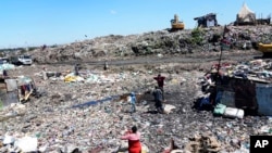 People scavenge recyclable materials for a living, at Dandora, the largest garbage dump in Nairobi, Kenya, April 22, 2024.