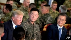 FILE - U.S. President Donald Trump and South Korean President Moon Jae-in, right, have lunch with U.S. and South Korean troops at Camp Humphreys in Pyeongtaek, South Korea, Tuesday, Nov. 7, 2017. (AP Photo/Andrew Harnik)