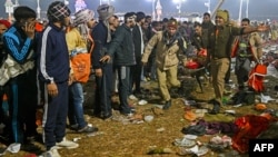 Police carry a victim of a stampede amid the ongoing Maha Kumbh Mela festival in Prayagraj city, India, Jan. 29, 2025.