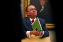 FILE - Acting White House chief of staff Mick Mulvaney listens in the Oval Office of the White House in Washington, Jan. 31, 2019.