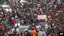 Protesters gather as thousands rally to call for the departure of South African company Waymark, which was hired by the Guinean government to re-do the country's electoral list, in Conakry, Guinea, September 20, 2012.