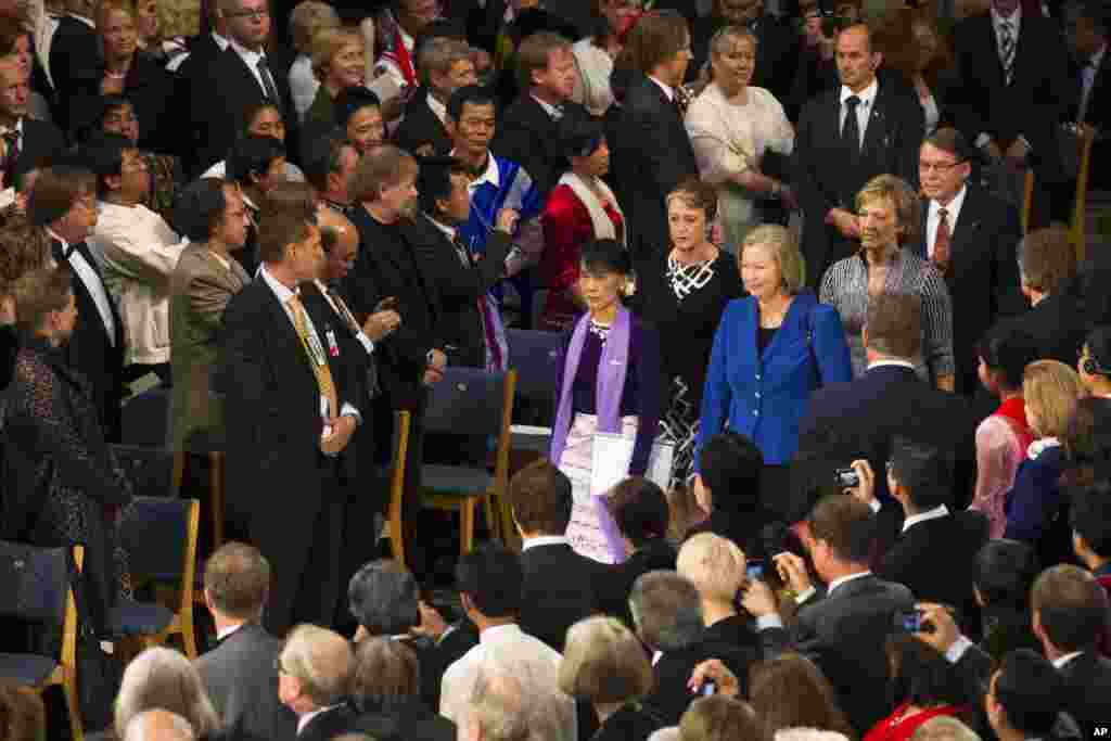 Aung San Suu Kyi, center, arrives for the Peace Nobel Prize lecture at the city hall in Oslo, June 16, 2012 to thank the Nobel committee for the prize she won in 1991.