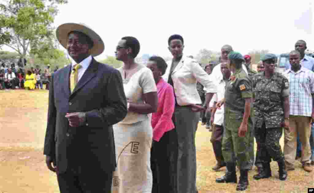 Uganda's President Yoweri Kaguta Museveni, wearing hat at left, stands in a queue as he waits with other voters to place his ballot in Kiruhura district, which is Museveni's home area, at a Polling station about 300 Kms (200 miles) west of Kampala, Ugand