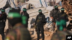 Hamas fighters take up positions ahead of a hostage release in Khan Younis, southern Gaza Strip, Feb. 1, 2025. 