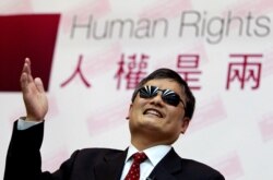 FILE - Chinese activist Chen Guangcheng gestures as he speaks to lawmakers and human rights supporters at the legislature in Taipei, Taiwan, June 25, 2013.