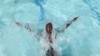 A child cools off in a public pool in Soweto, South Africa, Jan. 17, 2014. 