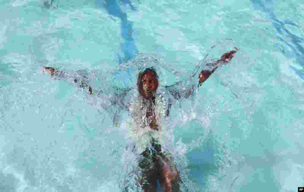 A child cools off in a public pool in Soweto, South Africa. The weather service has classified the current heat wave being experienced by parts of South Africa as &quot;extreme&quot;, and has warned that it is set to persist until Sunday. 