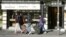 Asian tourists walk past a luxury watch shop in the Swiss alpine resort Interlaken, Switzerland, Nov. 17, 2015. Europe's travel industry could lose over $1 billion in revenues because of the impact of the Paris attacks, analysts say.