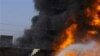 A Pakistani fire fighter tries to extinguish burning oil tankers after militants attacked a terminal in Quetta, Pakistan on Wednesday, Oct. 6, 2010. Gunmen in southwestern Pakistan torched a dozen tankers carrying fuel to NATO troops and killed a driver W