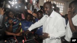 FILE - In this Oct. 10, 2017, file photo, former soccer star George Weah, presidential candidate for the Coalition for Democratic Change, casts his vote during the presidential election in Monrovia, Liberia. Liberians head to the polls on October 10, 2023.