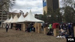 Cardboard voting booths are seen at a parking lot that has been temporarily converted into polling center, in downtown Nairobi, Kenya, Aug. 8, 2017. (J. Craig/VOA)