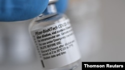 A vial containing doses of the Pfizer-BioNTech COVID-19 vaccine is seen at the Bavarian Red Cross vaccination center, in Pfaffenhofen an der Ilm