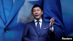 FILE - Yusaku Maezawa, the chief executive of Zozo, which operates Japan's popular fashion shopping site Zozotown and is officially called Start Today Co, speaks at an event launching the debut of its formal apparel items, in Tokyo, Japan, July 3, 2018.