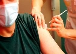 A man receives a Pfizer COVID-19 vaccine in Anglet, southwestern France, July 17, 2021.