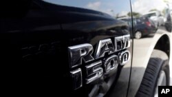 FILE - A Dodge Ram 1500 is on display on the lot at Planet Dodge in Miami, Oct. 1, 2014.