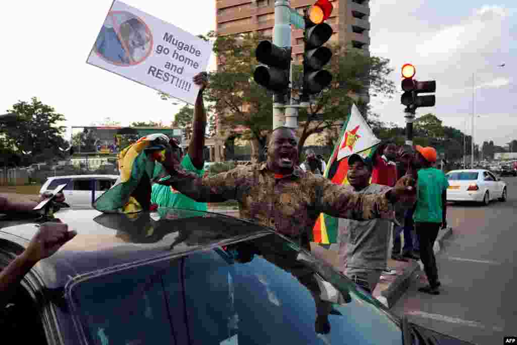 People celebrate in the streets after the resignation of Zimbabwe's president, Robert Mugabe, in Harare, Zimbabwe, Nov. 21, 2017. 