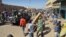 Malian troops try to dissuade the crowd from looting shops in Timbuktu, Jan. 29, 2013. Hundreds of Malians looted Arab-owned shops Tuesday in Mali's fabled Timbuktu, newly freed from Islamists. 