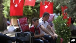 People rest in Kugulu Park in Ankara, Turkey, June 24, 2013. After weeks of sometimes-violent confrontation with police, Turkish protesters have found a new form of resistance: standing still and silent.