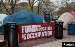 FILE— University of Michigan students camp in the Diag to pressure the university to divest its endowment from companies that support Israel on the University of Michigan college campus in Ann Arbor, Michigan, U.S., April 23, 2024.