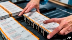 Photo provided by Pfizer shows boxes of kid-size doses of its COVID-19 vaccine, Oct. 2021