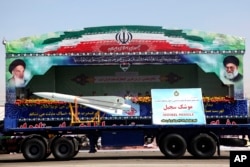FILE - Sedjeel, an Iranian made ballistic missile, is showcased during an annual military parade in Tehran, Iran, Sept, 22, 2013.