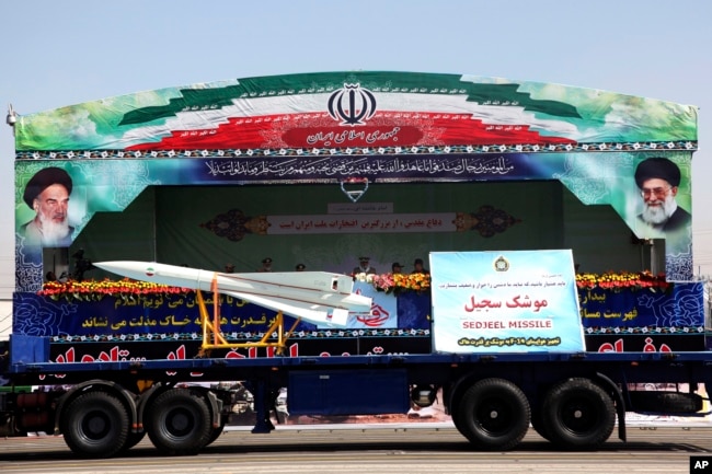 FILE - Sedjeel, an Iranian made ballistic missile, is showcased during an annual military parade in Tehran, Iran, Sept, 22, 2013.