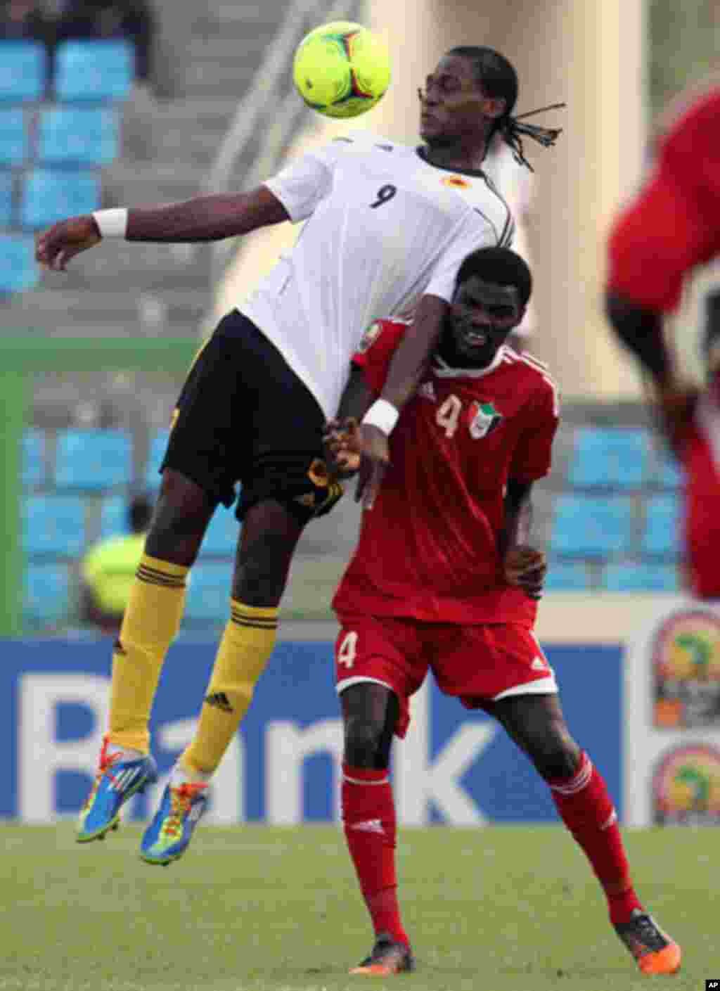Manucho of Angola fights for the ball with Nagm Eldim of Sudan during their African Nations Cup soccer match in Malabo