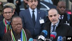 FILE-Accompanied with South Africa's Foreign Minister Naledi Pandor, left, Palestinian assistant Minister of Multilateral Affairs Ammar Hijazi addresses reporters after session of the International Court of Justice, or World Court, in The Hague, Netherlands, January 26, 2024.