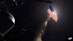 In this image provided by the U.S. Navy, the guided-missile destroyer USS Porter launches a Tomahawk land attack missile in the Mediterranean Sea, April 7, 2017.