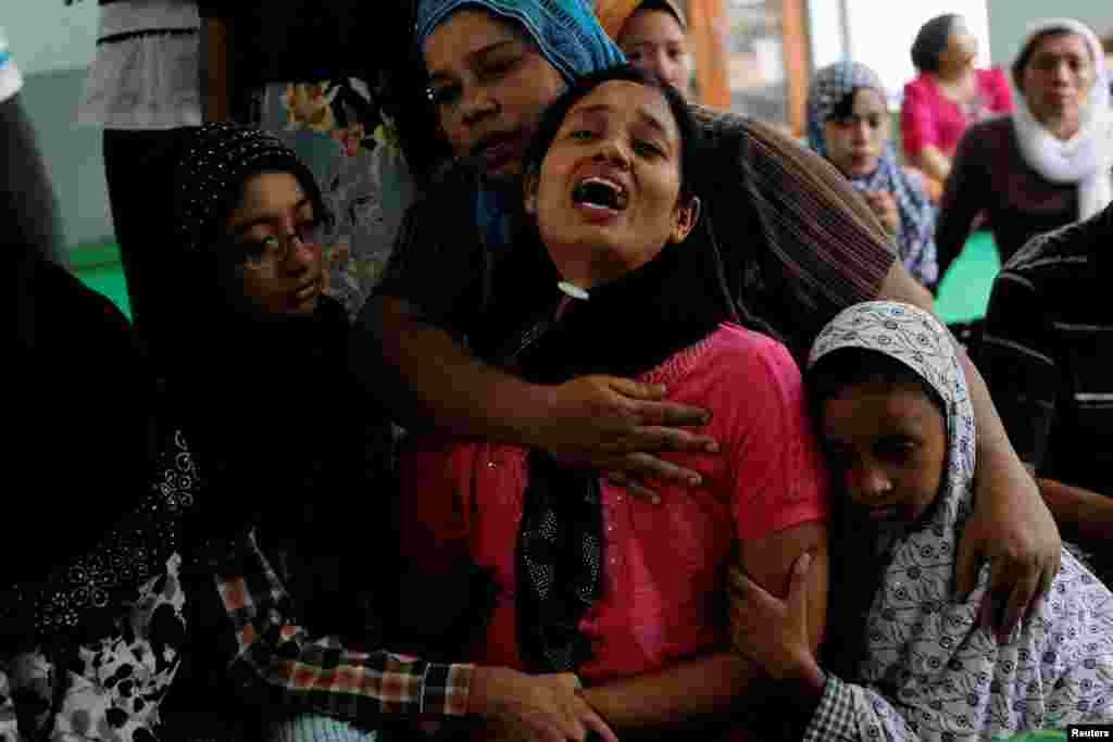 Tin Tin Kyaw cries near the body of her husband Soe Min, a 51-year-old man who was killed in a recent riot, at a mosque in Mandalay, Myanmar, July 3, 2014. 