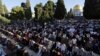 Palestinians pray in front of the Dome of the Rock shrine in Jerusalem, June 15, 2018 during the traditional morning prayer of the Muslim holiday of Eid al-Fitr.