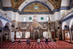 Israeli Arabs pray at the El-Jazzar Mosque in the old city of Acre, northern Israel, Sept. 24, 2019.