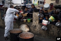 Palestinians line up for food in Rafah, Gaza Strip, on Feb. 23, 2024.