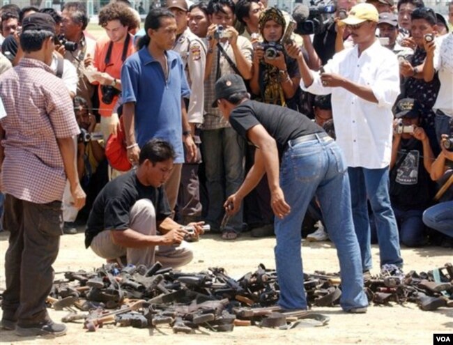 Para anggota Gerakan Aceh Merdeka (GAM) menyerahkan berbagai senjata kepada Aceh Monitoring Mission (AMM) di Banda Aceh, September 2002. (Foto: Dok)