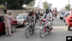 FILE - Taliban fighters ride their motorbikes inside Ghazni city, capital of Ghazni province, west of Kabul, Afghanistan, June 16, 2018. 