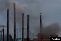 Smoke rises from the chimney of a paper factory outside Hanoi, Vietnam, May 21, 2018.